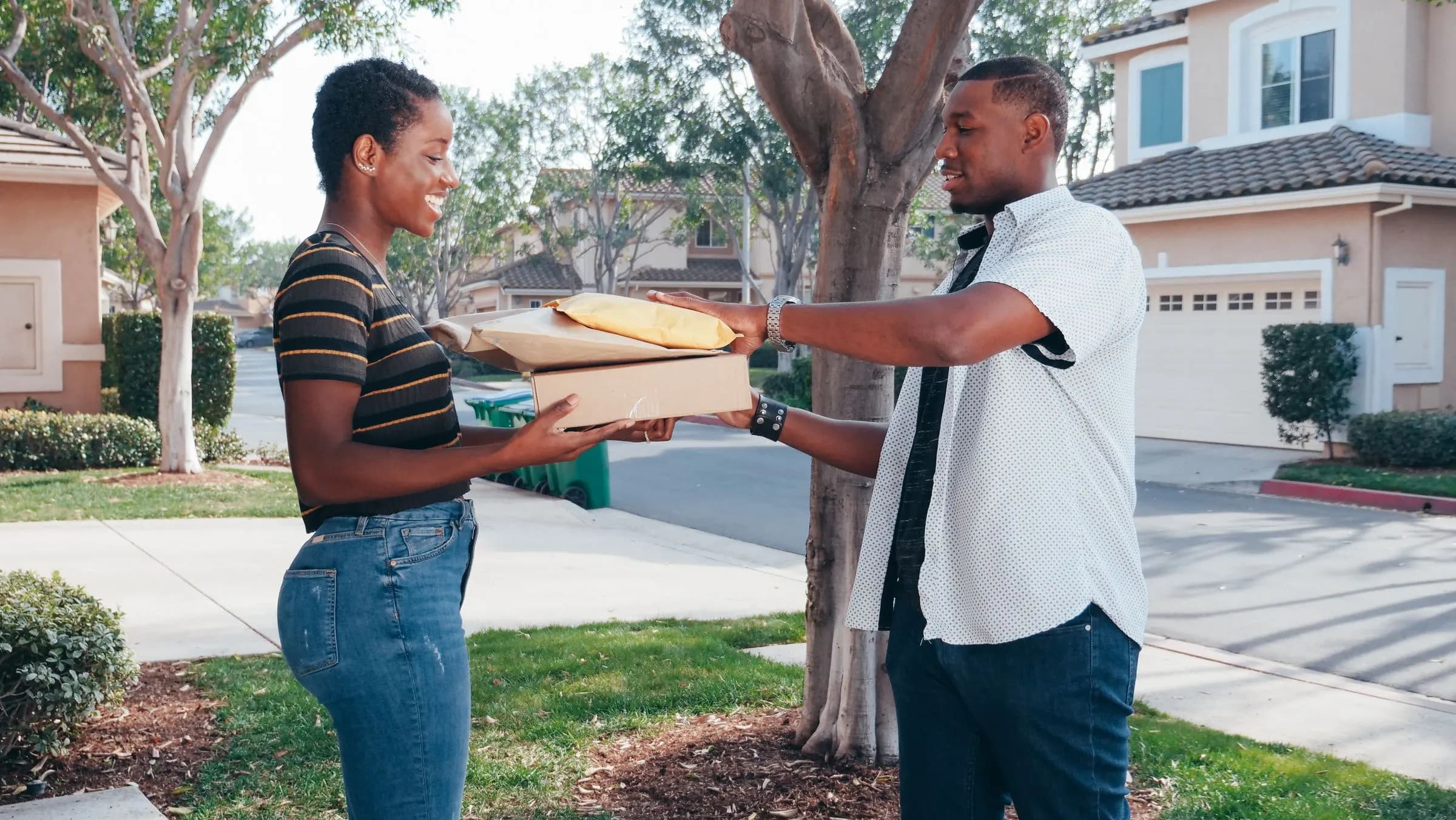 A delivery agent handing documents to a resident outside her home